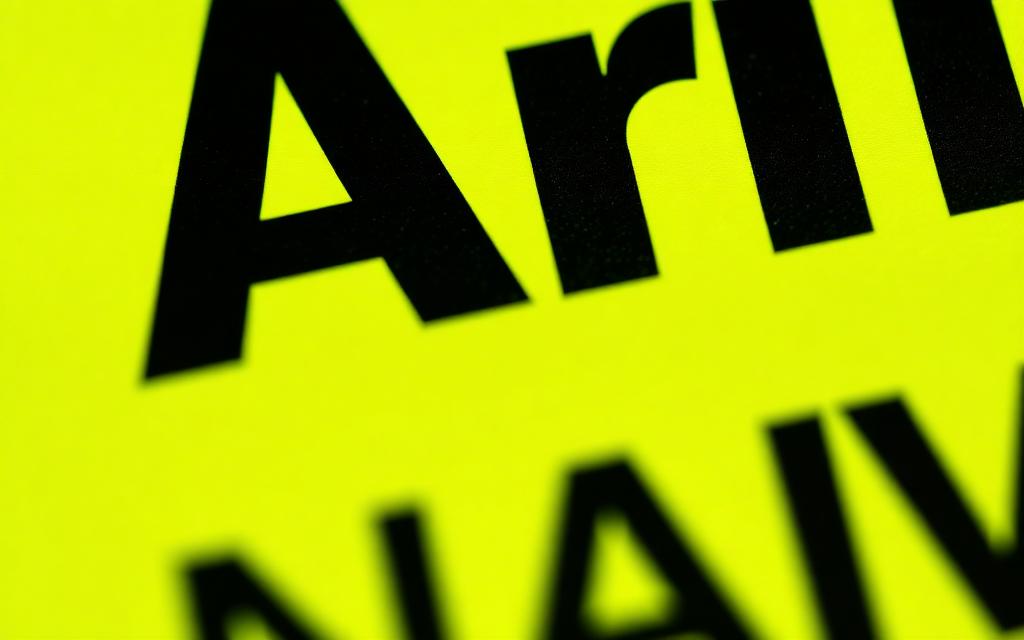 Close-up of the brat font Arial Narrow Bold lowercase on lime green